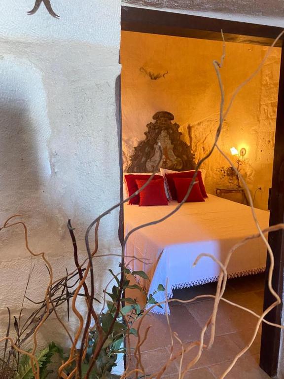 a bedroom with a bed with red pillows on it at Appartamenti del Re in Ostuni