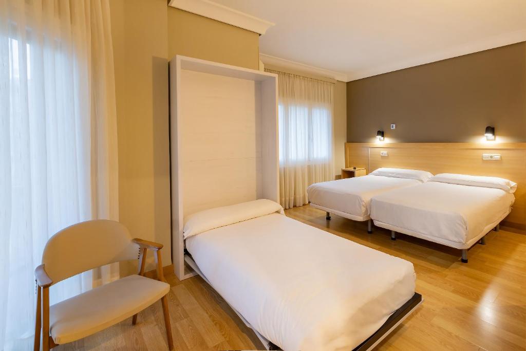 Postel nebo postele na pokoji v ubytování Hotel Santamaria