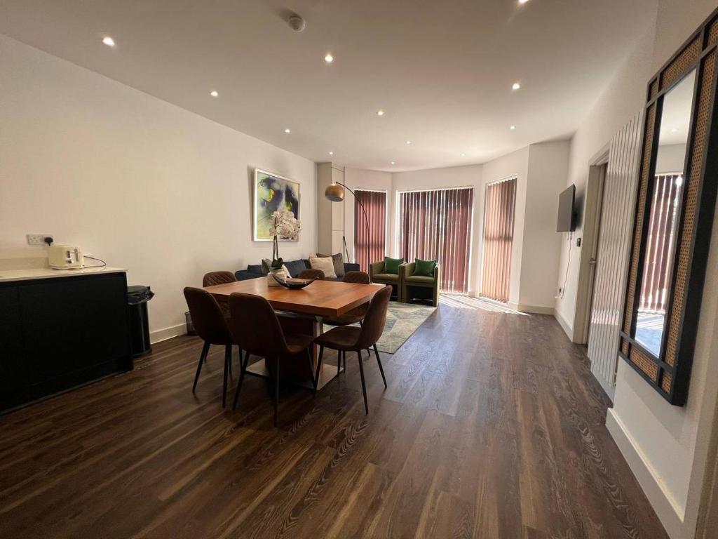 a living room with a wooden table and chairs at Star London Finchley Road 3-Bed Escape with Garden in London