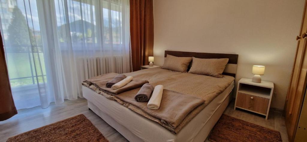 a bedroom with a large bed with two towels on it at VIEW APARTMENT in Visoko