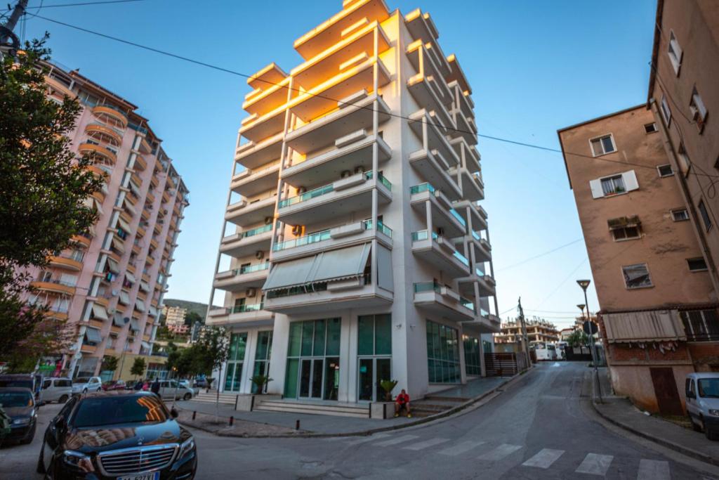 an apartment building in the middle of a street at Mamma's Apartments in Sarandë