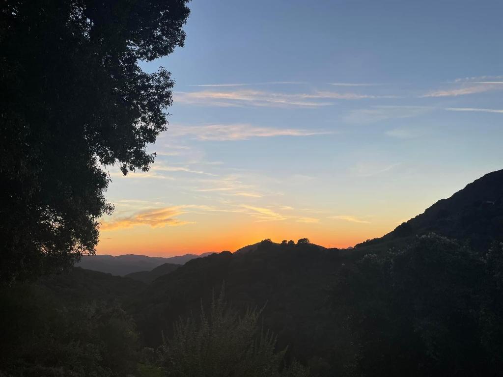 a sunset in the mountains with a view of the valley at Casa Ditta in Mela