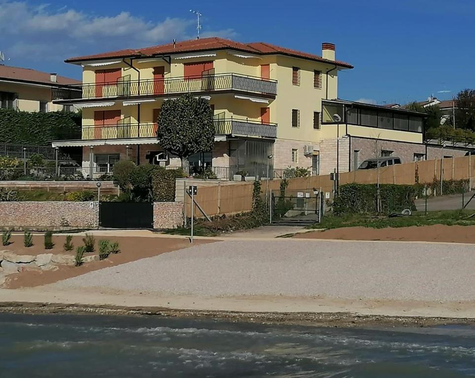 a large house with a road in front of it at CASA COSTA AL SOLE APARTMENT 2 in Lazise