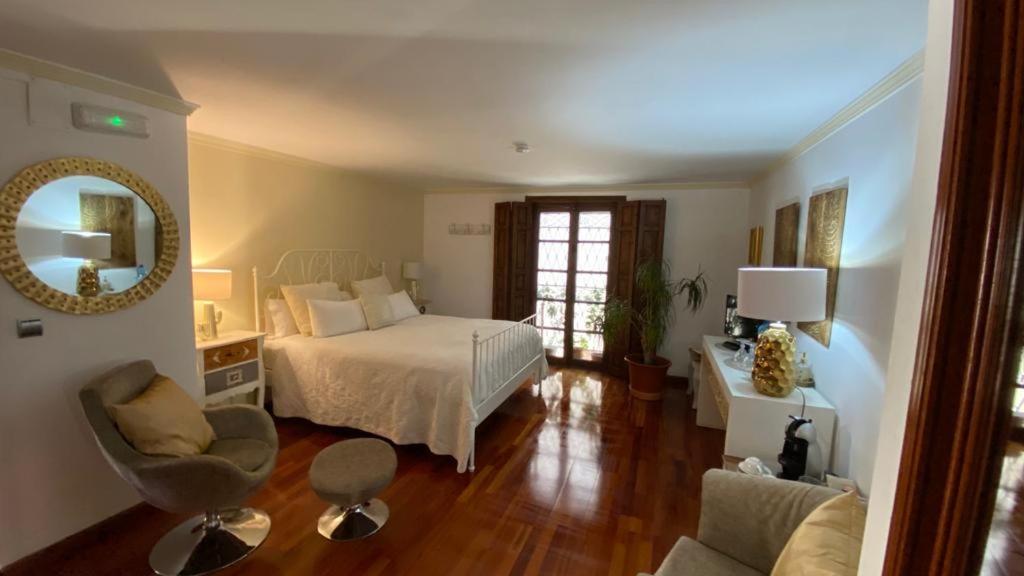 een slaapkamer met een bed, een bureau en een stoel bij La Posada de Chinchilla in Chinchilla de Monte-Aragón