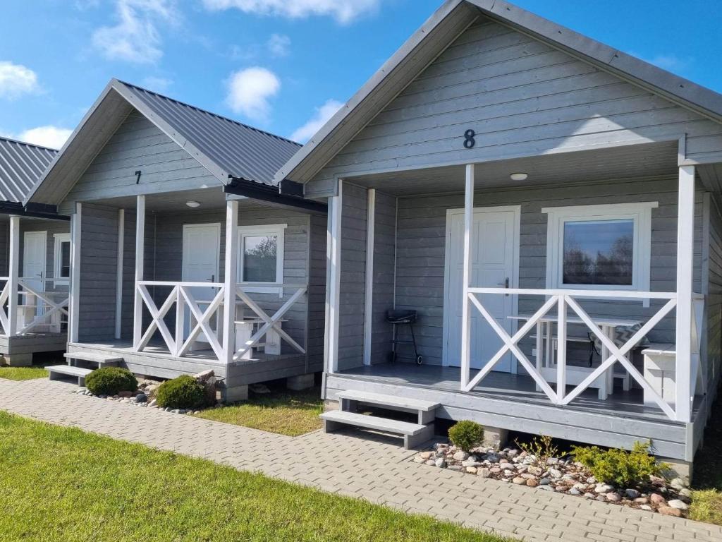 a gray house with white doors and windows at NOWE Domki letniskowe Pod Sosenką- 4min od morza! Wicie in Wicie