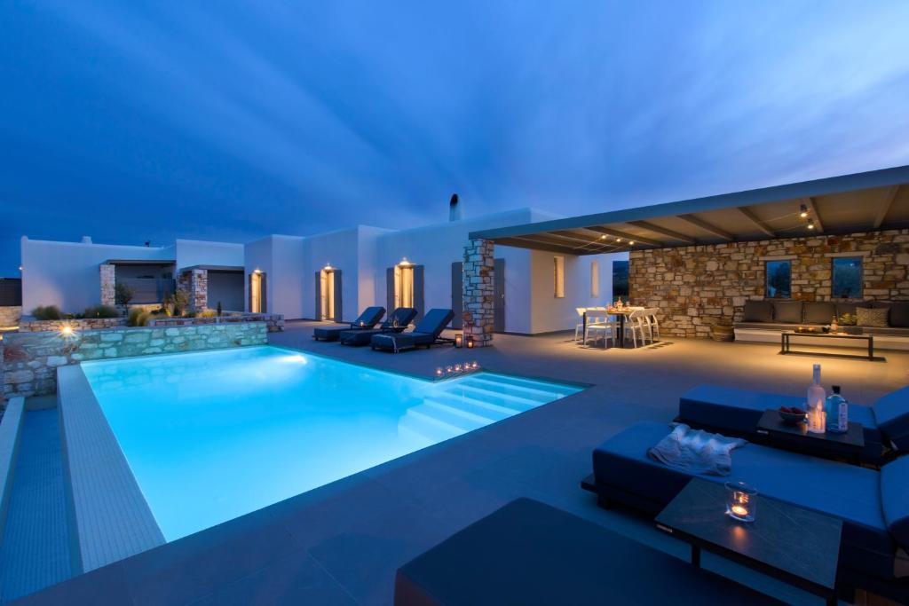 a pool in a house with blue lighting at IL SOGNO VILLA 3 in Isterni