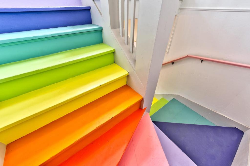 a group of colorful stairs in a room at Lincoln Lodge A near OU Med Bricktown Arena in Oklahoma City