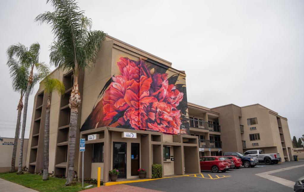 a building with a painting on the side of it at Hotel Milagro in Chula Vista