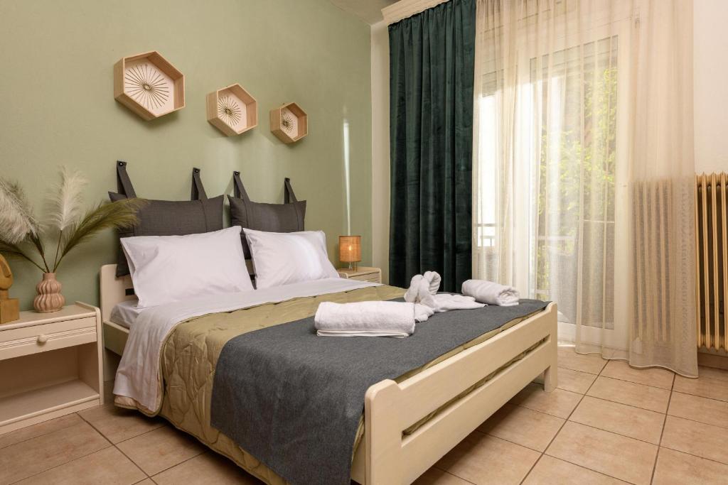 a bedroom with a large bed with towels on it at El Nido Apartment in Limenas