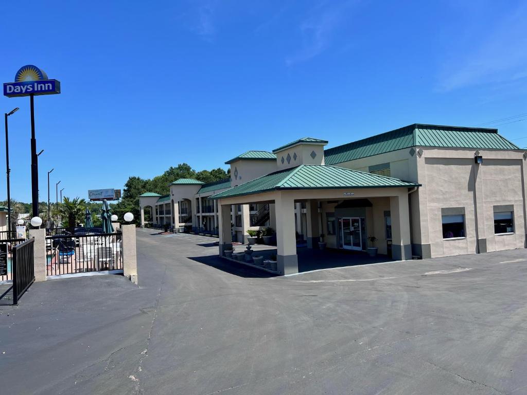 an empty parking lot in front of a building at Days Inn by Wyndham Greenville in Greenville