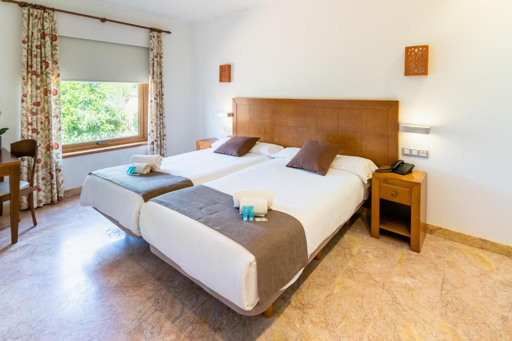 Postel nebo postele na pokoji v ubytování Hotel Riad Arruzafa