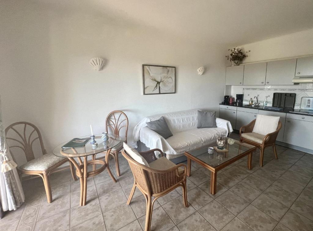 a living room with a couch and a table and chairs at 233 Casa Galo Verde Apartments in Porches