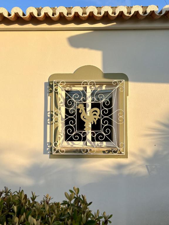 a clock on the side of a building at 233 Casa Galo Verde Apartments in Porches