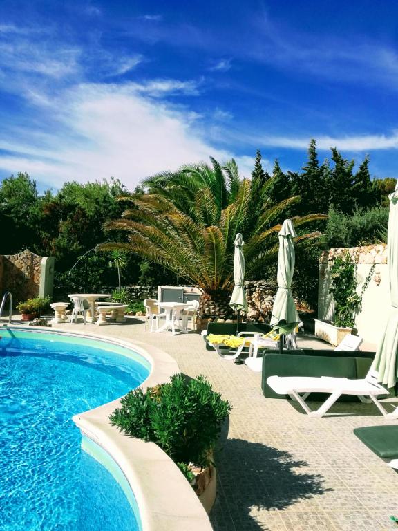 a pool with chairs and umbrellas next to a resort at 233 Casa Galo Verde Apartments in Porches