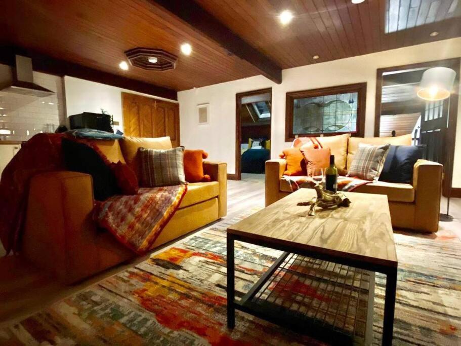 a living room with couches and a coffee table at Church Heights by Flying Stays in Pontypool