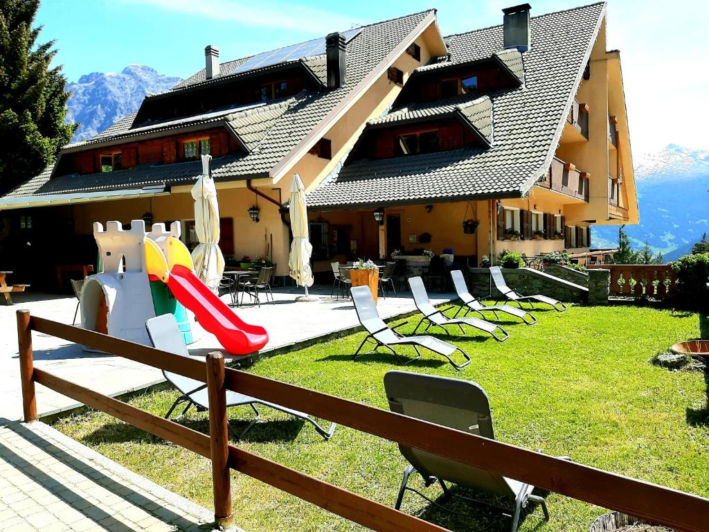 a group of chairs in front of a building at Residence Mirage in Oga