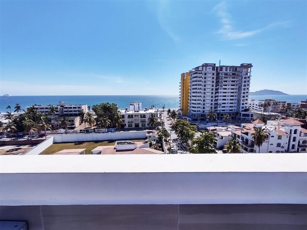 a view of the ocean from the balcony of a building at XMX Pacific Pearl in Mazatlán