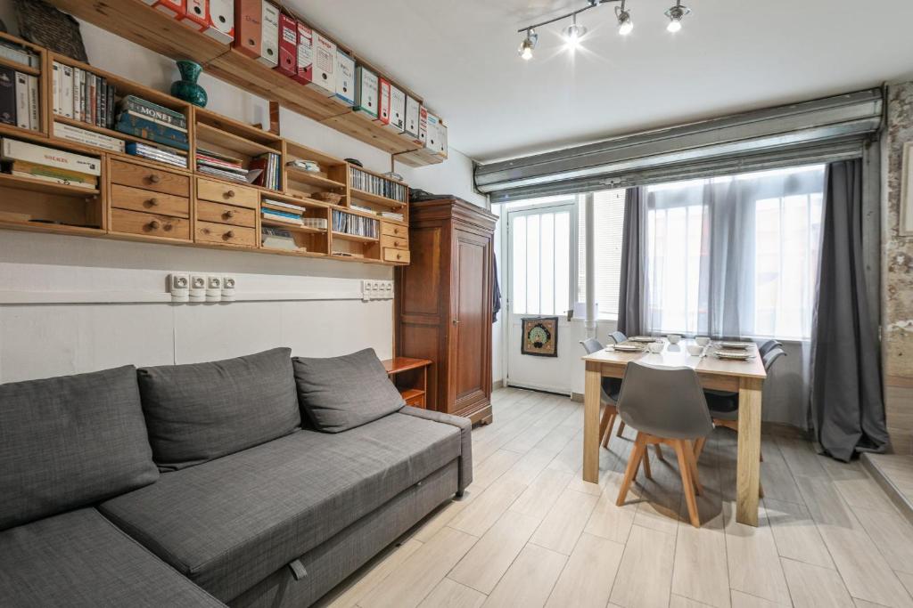 a living room with a couch and a table at Comfortable 1br in the 11th district of Paris - Welkeys in Paris