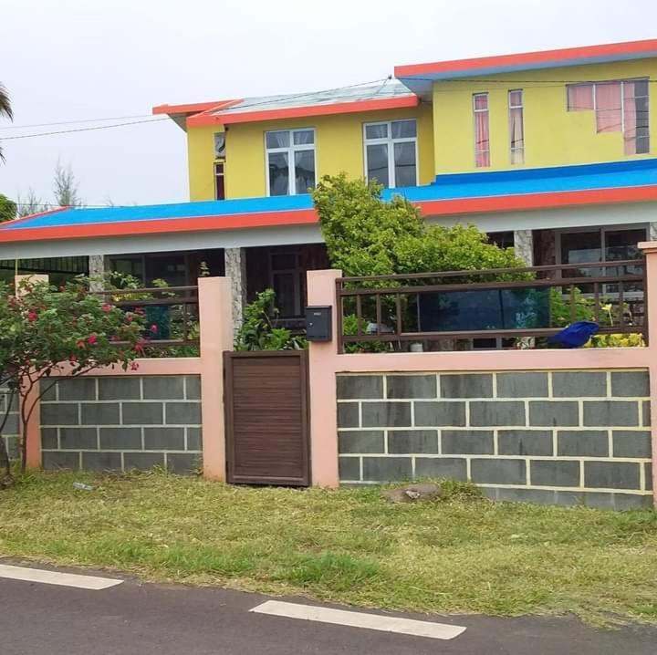 a house with a fence in front of it at Sur la route des tortues in Rodrigues Island