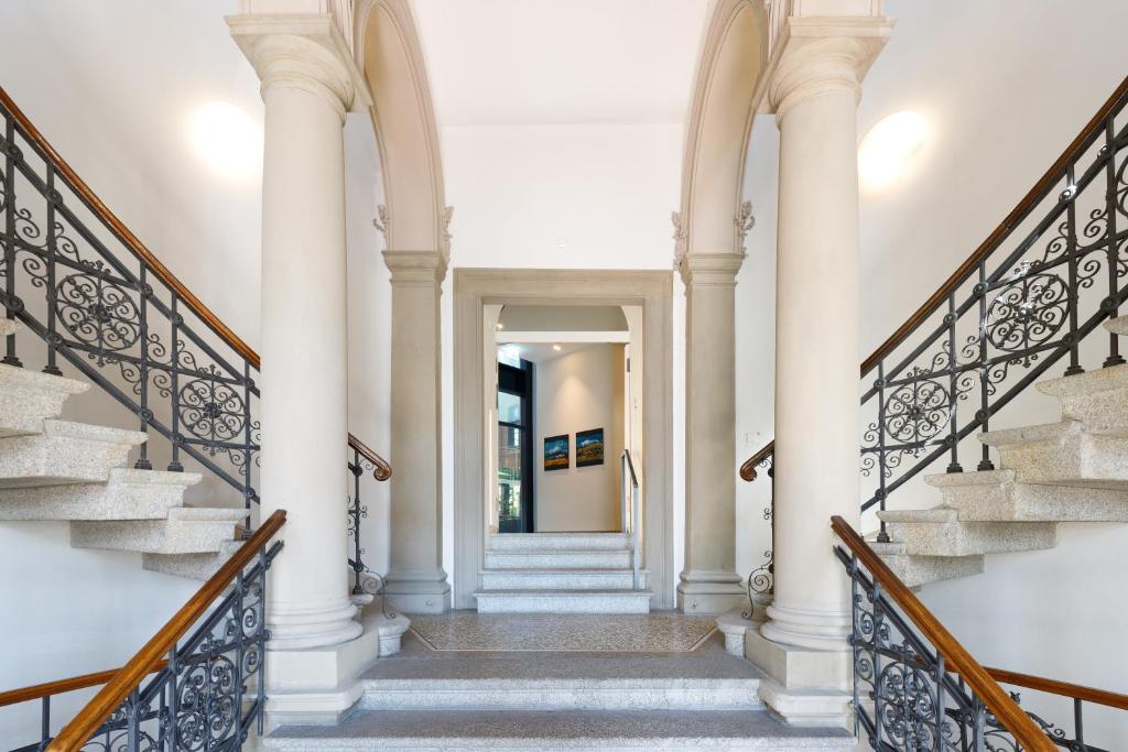 a hallway of a home with stairs and pillars at Hotel Alte Post in Konstanz