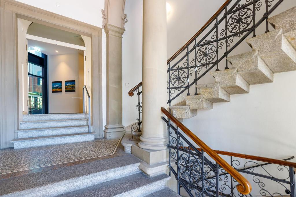 a staircase in a home with white walls at Hotel Alte Post in Konstanz