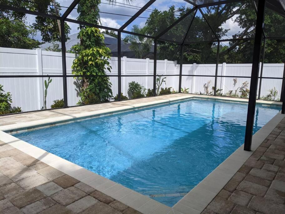 a large blue swimming pool with a white fence at Florinda 3bdr/2bth 2car garage with New Pool in Sarasota