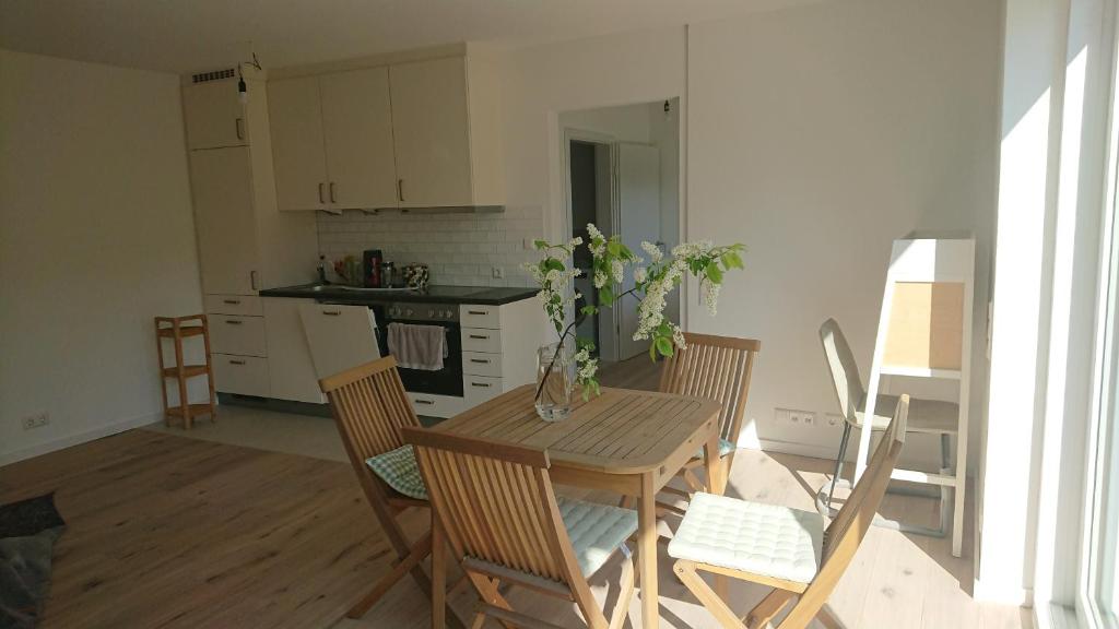 a kitchen with a wooden table and chairs and a kitchen with a table at Ruhezeit in Stockach
