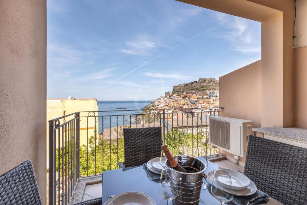 balcón con mesa y vistas al océano en IL Castello incantato en Castelsardo