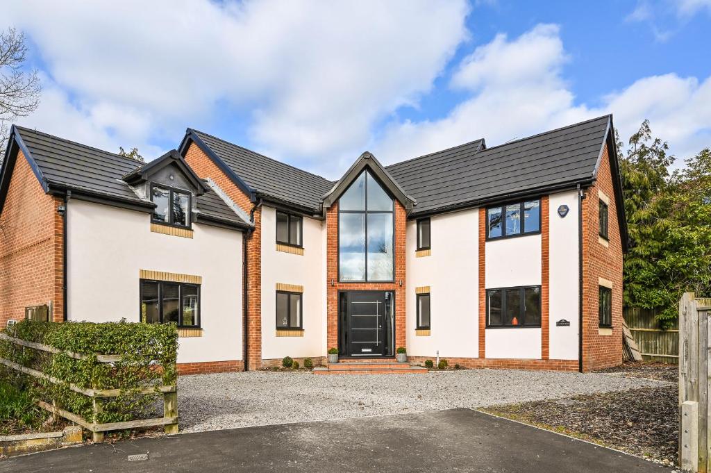 an exterior view of a house with a driveway at Stunning Detached House in Bassett in Southampton