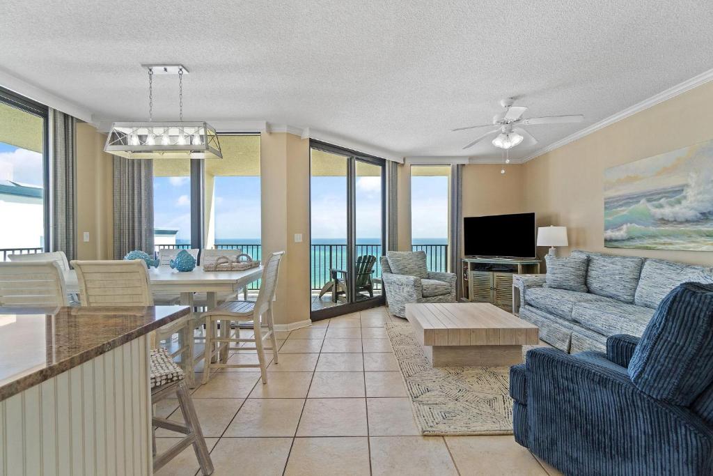 a living room with a couch and a table at Phoenix VIII 1406 in Orange Beach
