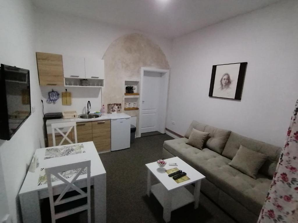a living room with a couch and a table at Apartman Dukat in Višegrad