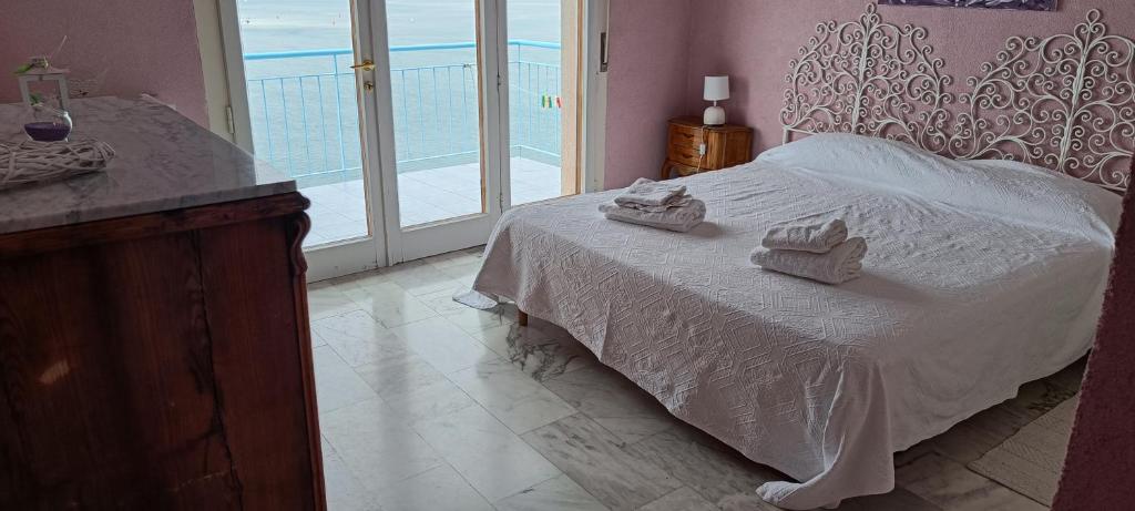 a bedroom with a bed with two towels on it at Locazione Turistica Sul Mare Strada Costiera 244, Trieste in Santa Croce Mare