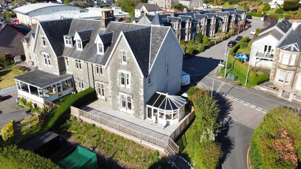 an aerial view of a large house on a street at Kenavara House in Oban