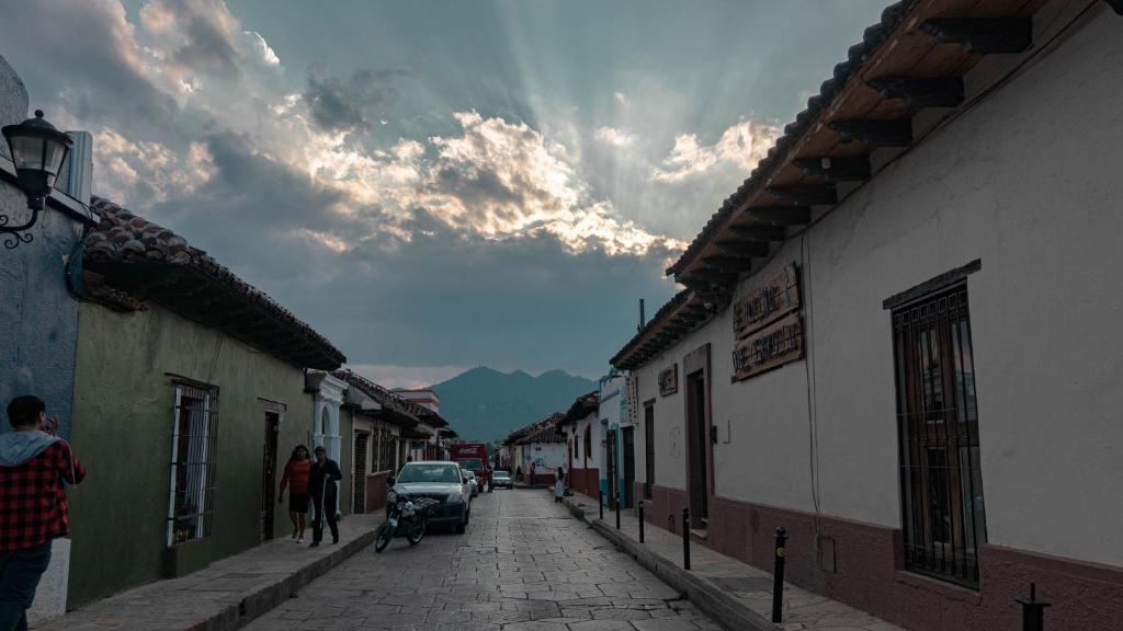 a street with buildings and a car parked on the street at Hotel Molino del Cerrillo in San Cristóbal de Las Casas