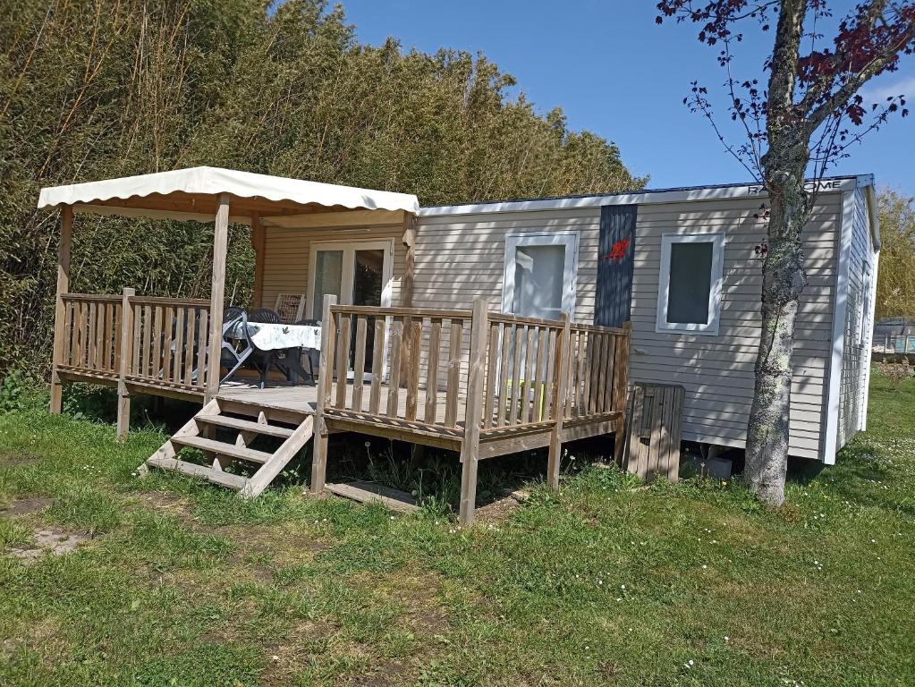 a tiny house with a porch and a deck at Le panorama in Guérande