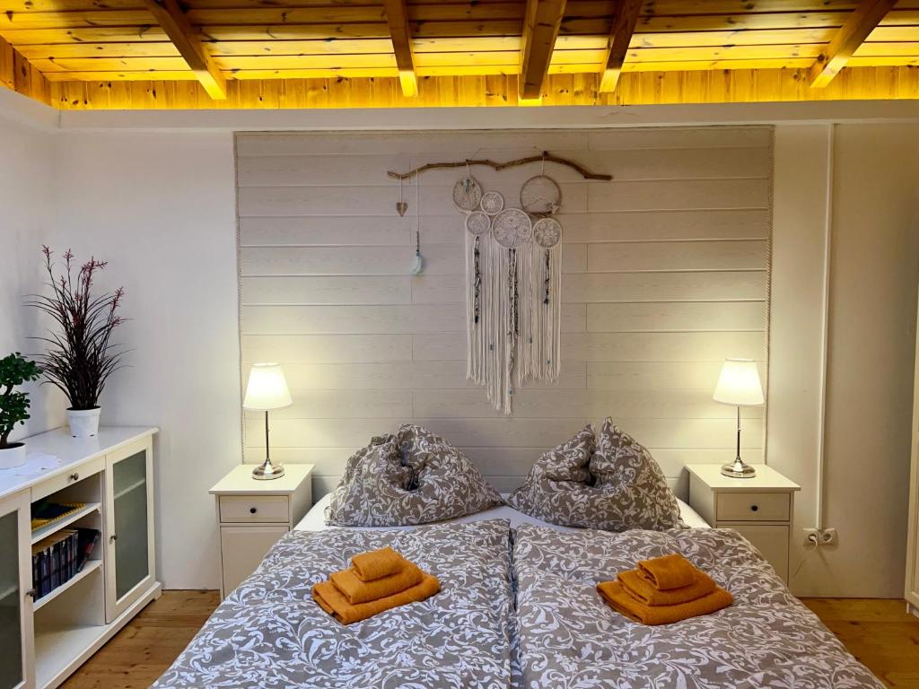 a bedroom with a bed with two pillows on it at Sommerhaus Zur Eule in Klosterneuburg