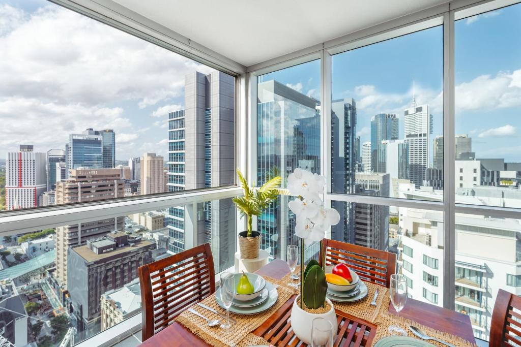 a dining room with a view of the city at Phenomenal City View Central Location 2BD Apart in Brisbane