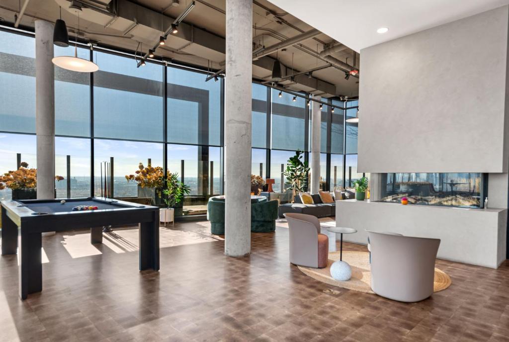 a living room with a pool table and a bill at Avra Stylish Apartments Prime West Loop Location Near Union Park in Chicago