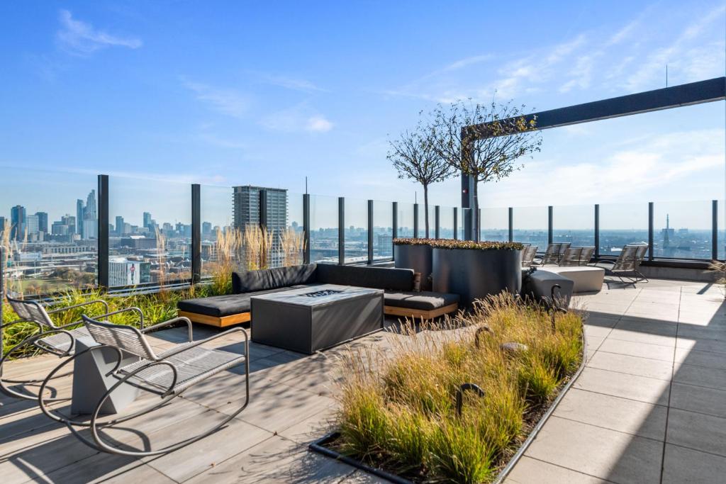 a patio with a couch and chairs on top of a building at Avra Stylish Apartments Prime West Loop Location Near Union Park in Chicago