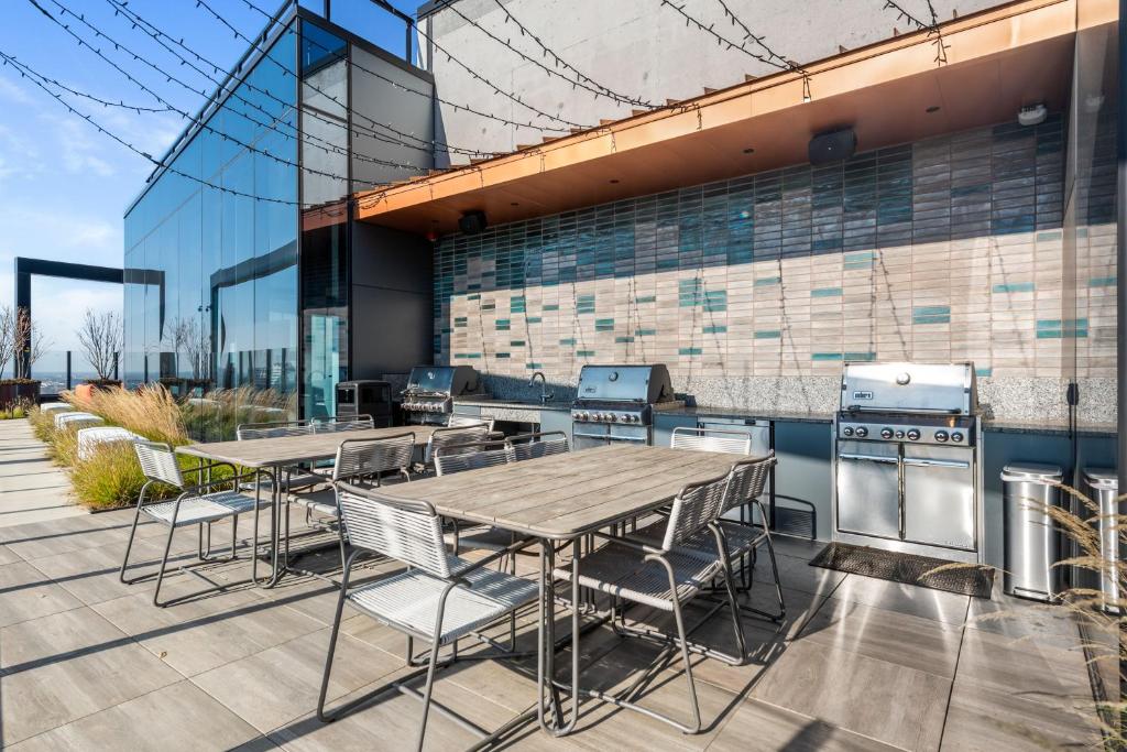 a patio with a table and chairs and a stove at Avra Stylish Apartments Prime West Loop Location Near Union Park in Chicago