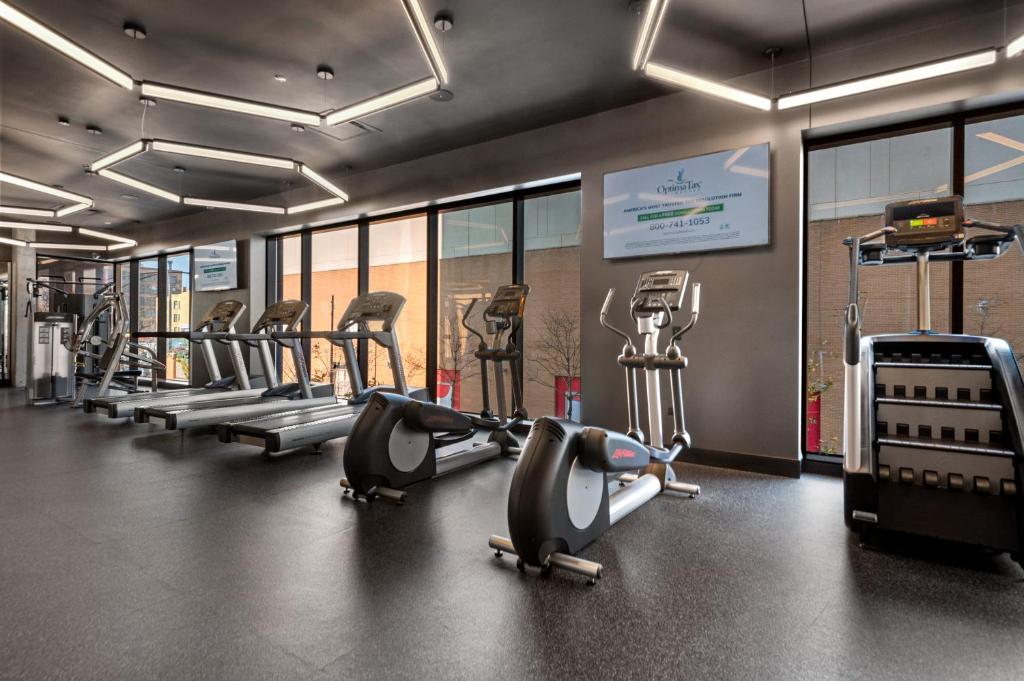 a gym with rows of treadmills and elliptical machines at Avra Stylish Apartments Prime West Loop Location Near Union Park in Chicago