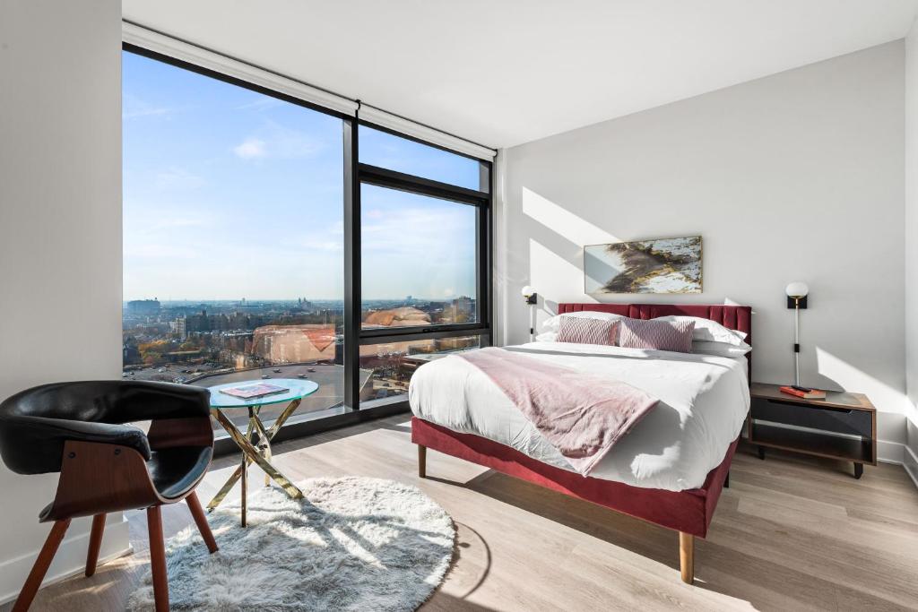 a bedroom with a bed and a large window at Avra Stylish Apartments Prime West Loop Location Near Union Park in Chicago