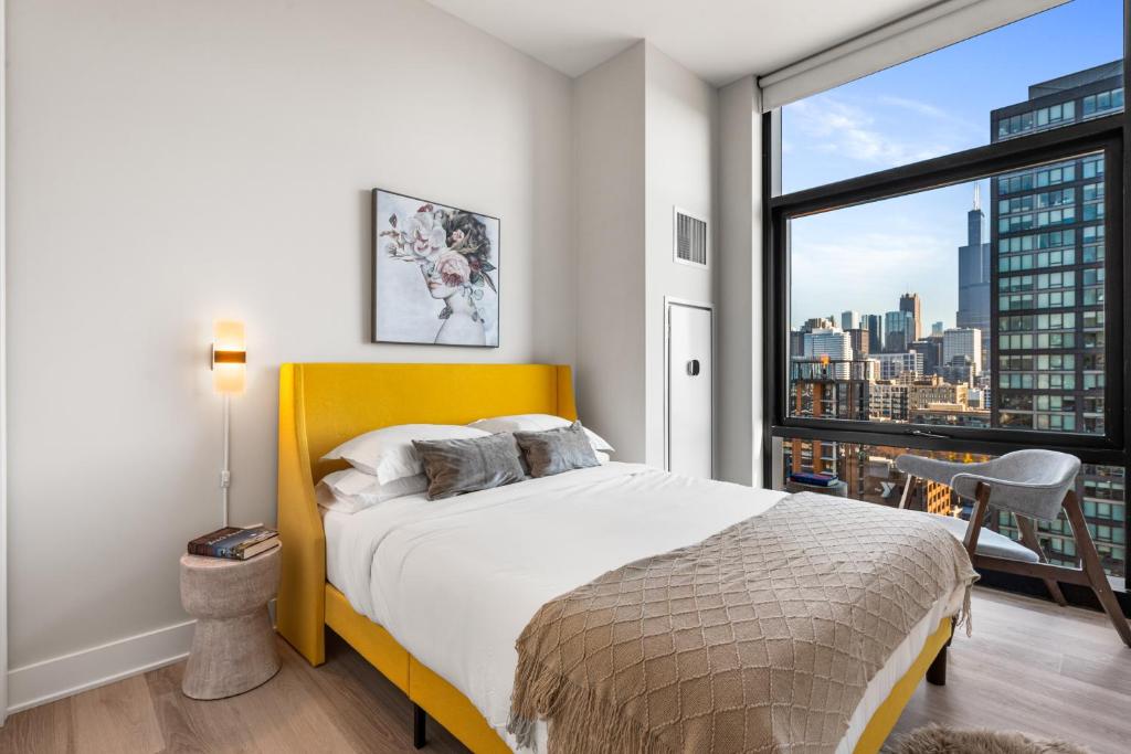 a bedroom with a bed and a large window at Avra Stylish Apartments Prime West Loop Location Near Union Park in Chicago