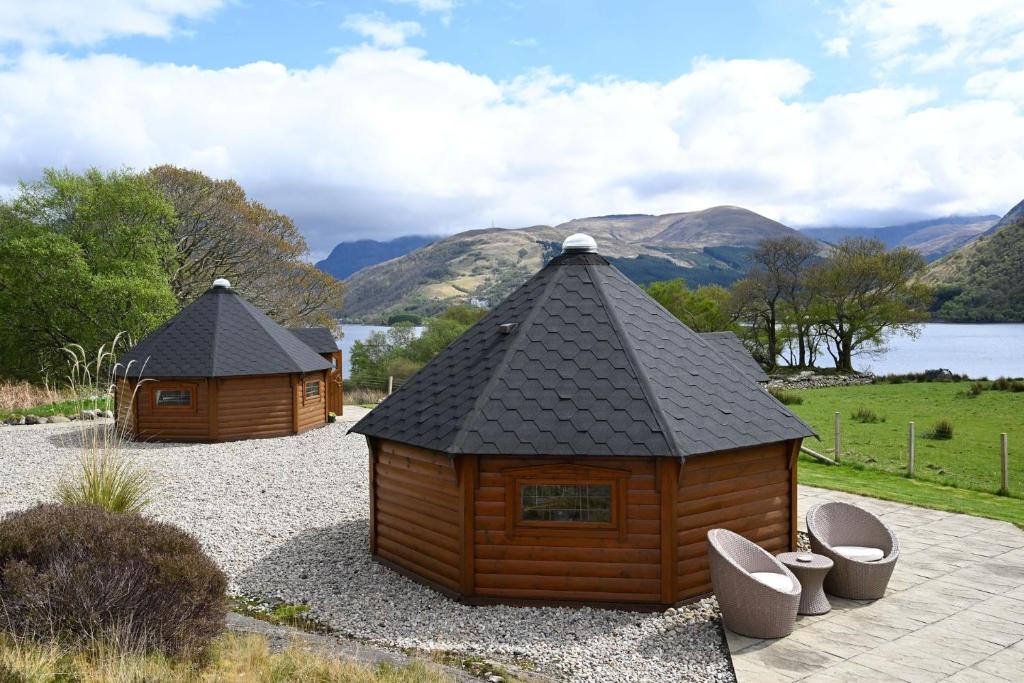 two small wooden buildings sitting on top of gravel at Leven View Lodges - Callart in Fort William