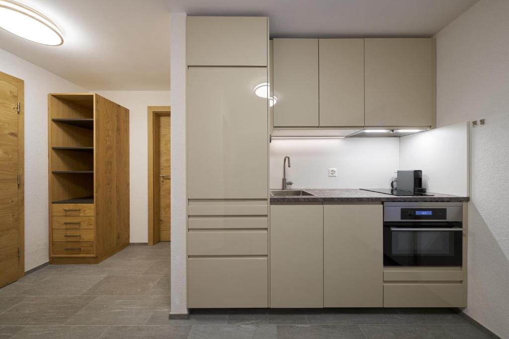Kuchyň nebo kuchyňský kout v ubytování Aparthotel Grischuna