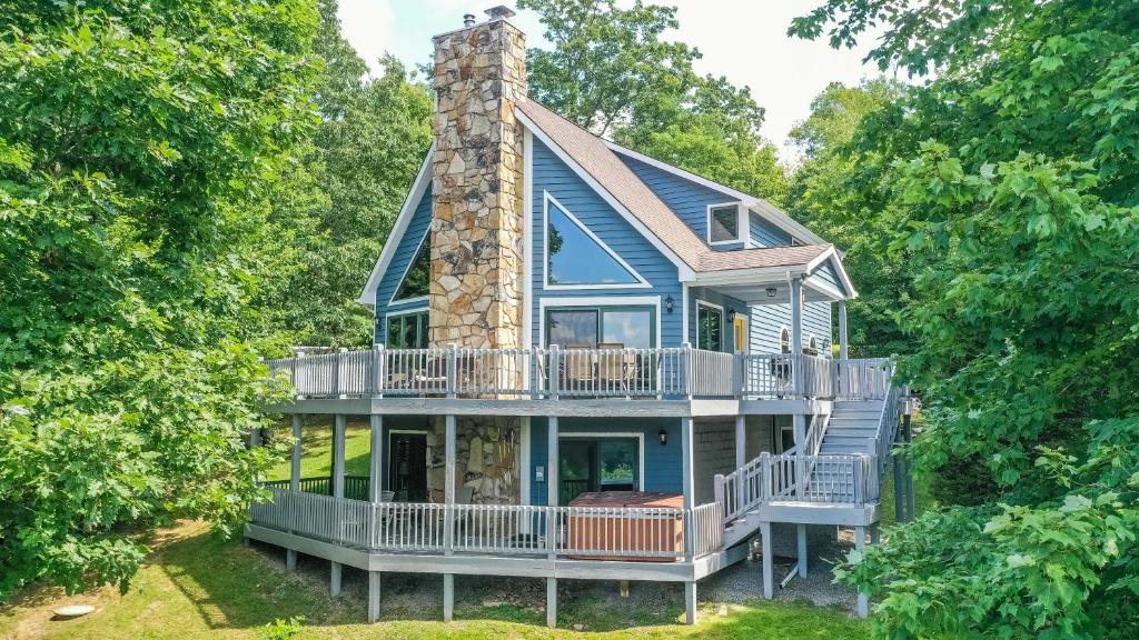 a house with a wrap around porch and a chimney at Tranquility in McHenry