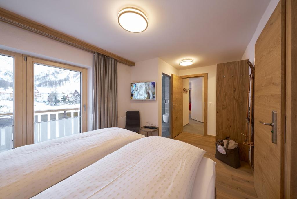 Postel nebo postele na pokoji v ubytování Aparthotel Grischuna