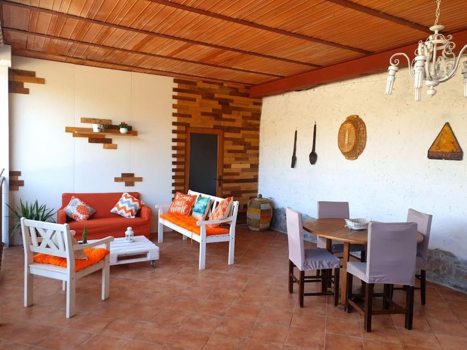 a living room with a couch and a table and chairs at Il Truciolo in Castellaccia