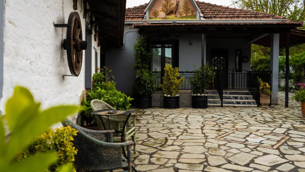 a house with a stone patio in front of a house at Country Side Cozy Villa in Kalabaka