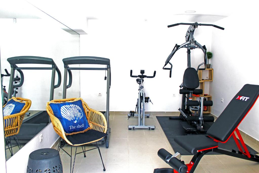 a gym with two exercise bikes in a room at Villa Almy in Plaka